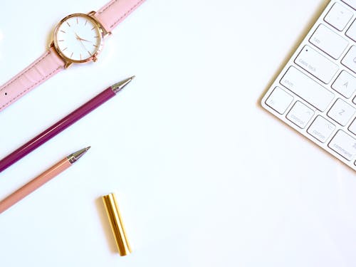 Free Round Gold-colored Watch and Two Pens Stock Photo