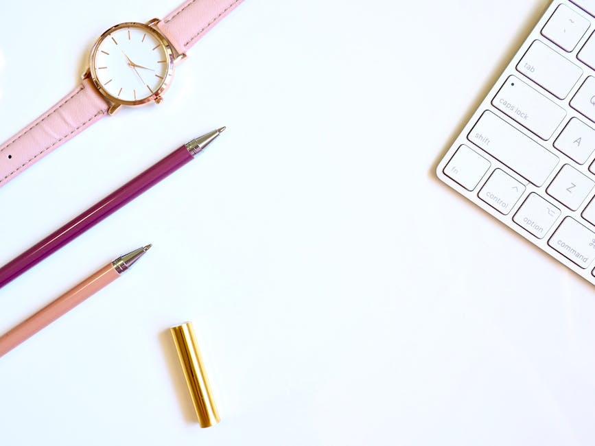 Round Gold-colored Watch and Two Pens