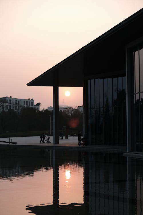 Silhouette of House near Body of Water