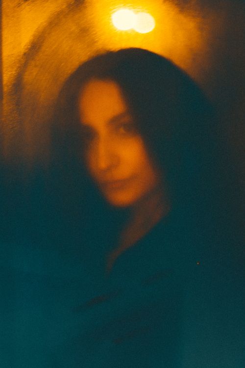 Free Ethereal and abstract portrait of a woman in warm, defocused light. Stock Photo