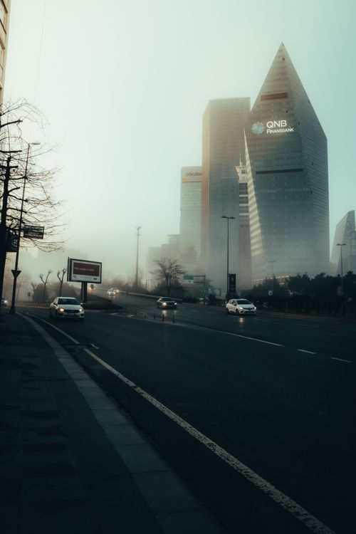 Free Foggy morning view of cityscape with prominent modern skyscrapers and street traffic. Stock Photo