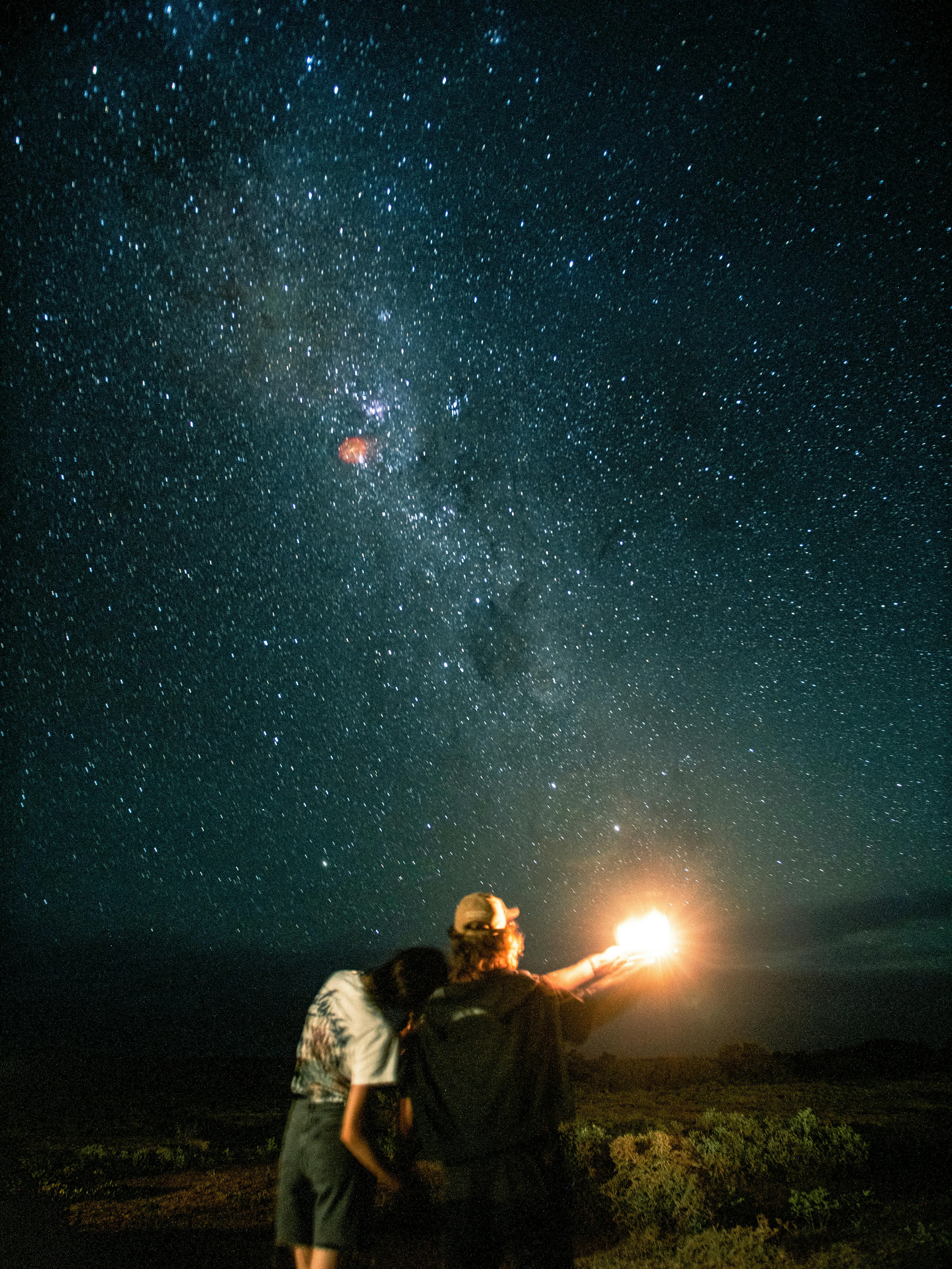 couple admiring view of milky way in night sky