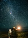 Couple Admiring View of Milky Way in Night Sky