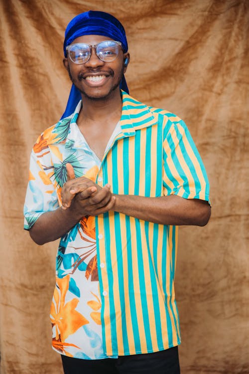 Man Wearing Striped and Floral Shirt Smiling