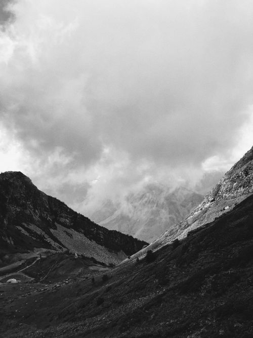 Free Grayscale view of mountainous terrain with dramatic clouds. Stock Photo