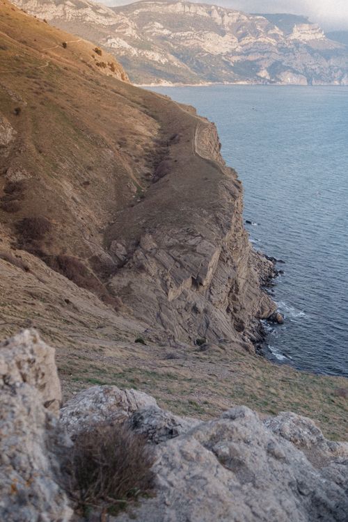 Free A scenic view of rugged cliffs meeting the ocean, depicting nature's beauty. Stock Photo