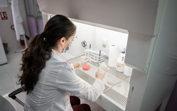 Woman In White Long Sleeve Shirt In Laboratory