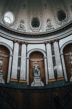 Statues Beside Marble Walls