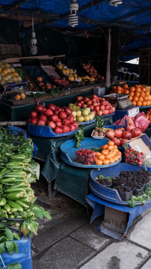 Free Colorful display of fresh fruits and vegetables at an Istanbul market stall. Perfect shot capturing the essence of local Turkish markets. Stock Photo