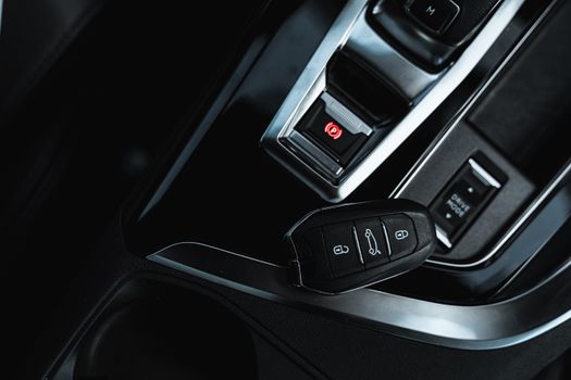 

A Close-Up Shot of a Car Key and an Electronic Handbrake