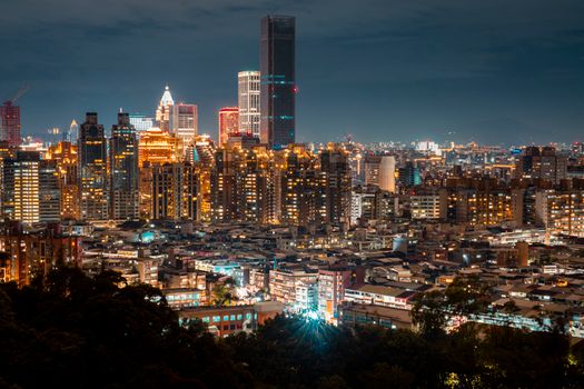 A breathtaking aerial view of a vibrant city skyline illuminated at night.