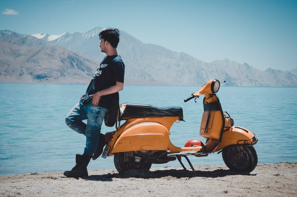 Photo of Man Leaning on Motorcycle