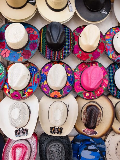 Free Vibrant collection of traditional hats with colorful patterns on display for purchase. Perfect for cultural and fashion themes. Stock Photo