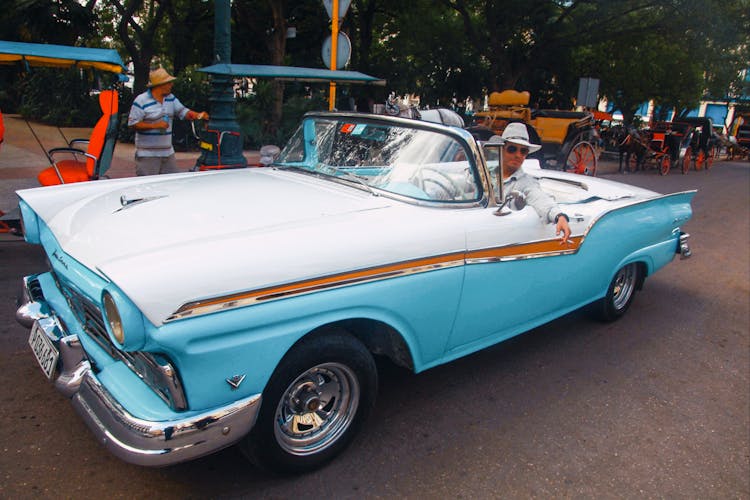 A Man Driving A Vintage Car