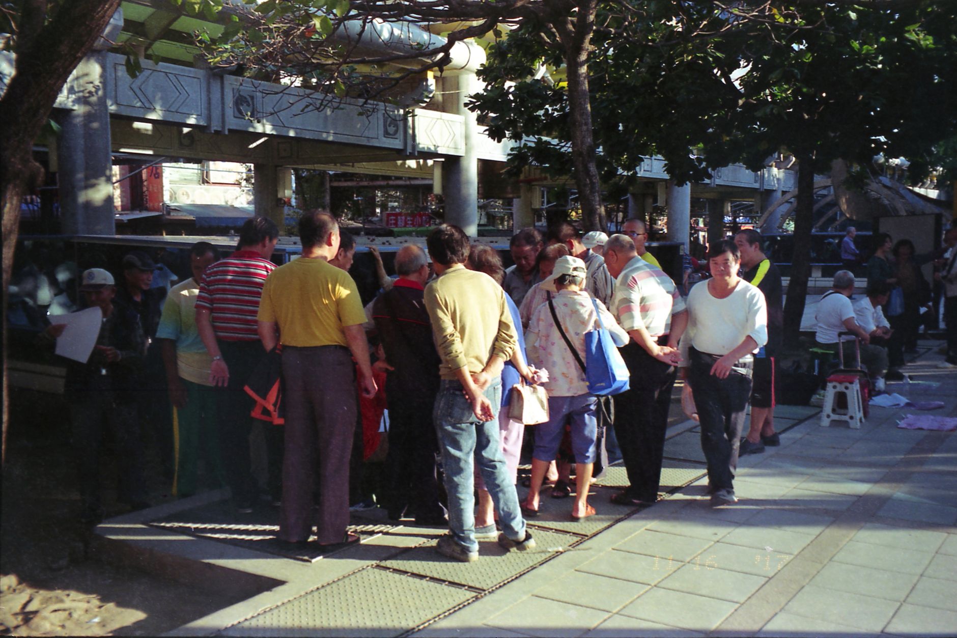 A vibrant crowd gathers in a New Taipei City park for public entertainment.