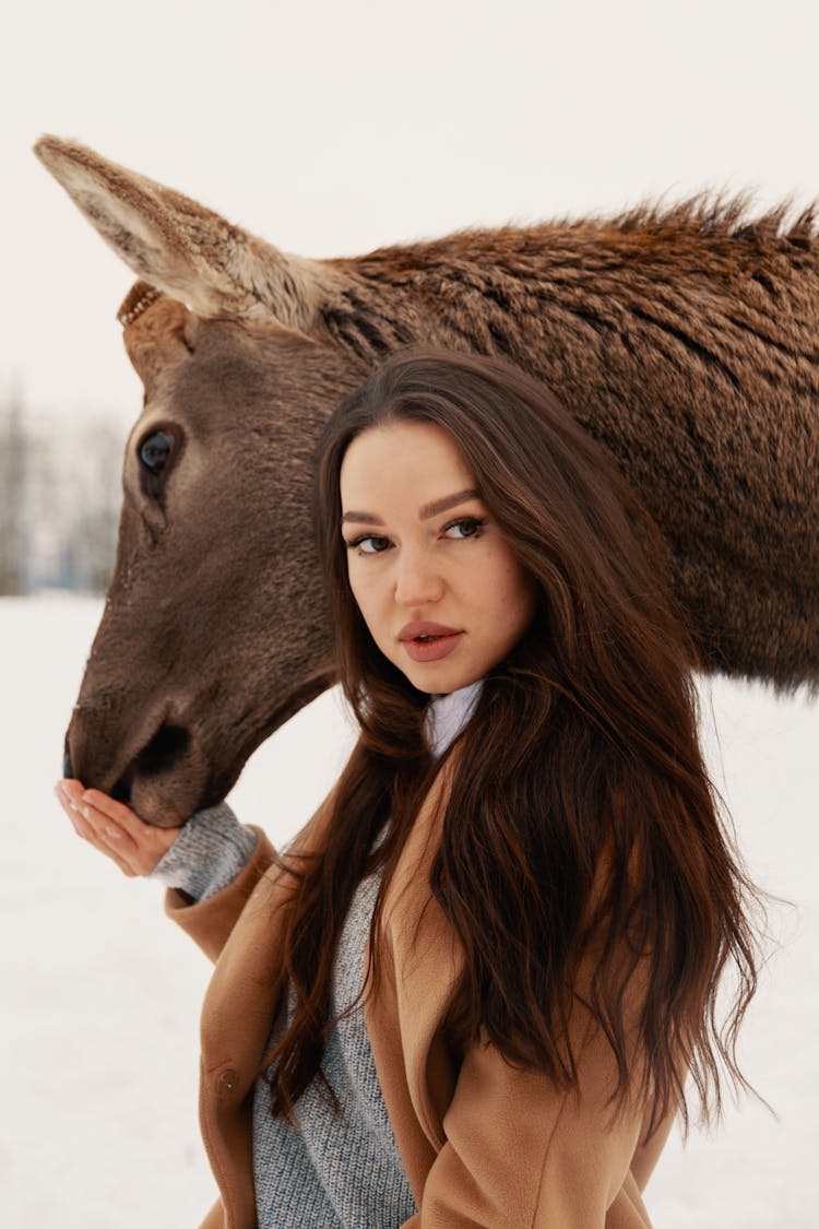 Portrait Of Woman Petting Deer