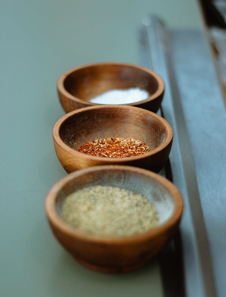 Close-Up Shot Of Seasonings In Wooden Bowls 