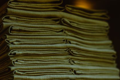 Folded linen fabric in soft daylight, photo by Ruslan Rozanov on Pexels