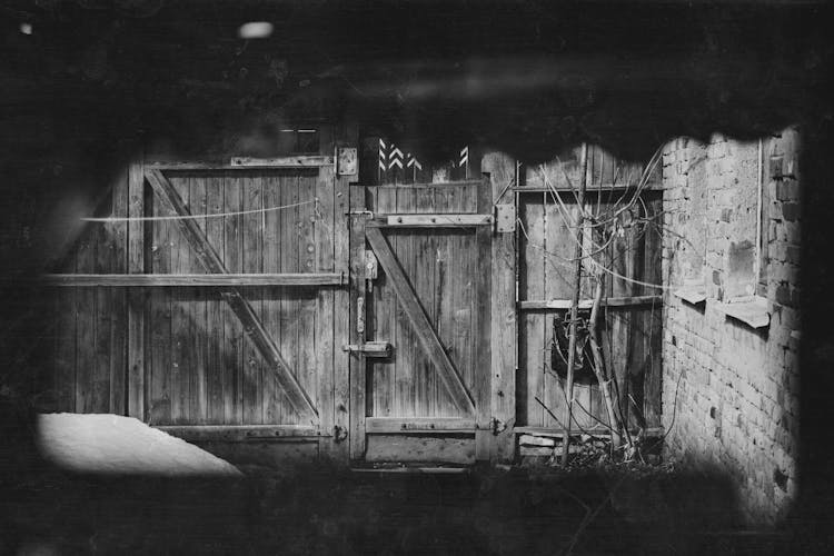 Grayscale Photo Of Wooden Door With Locks