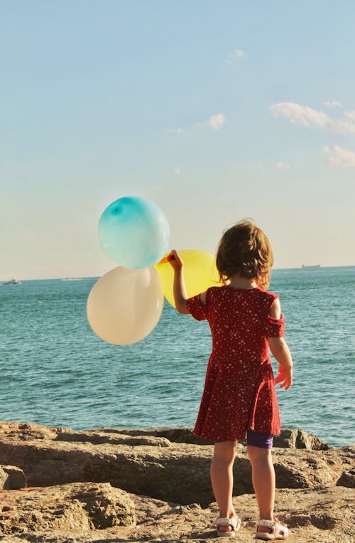 Girl in Red Dress Holding Balloons 