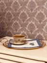 White Ceramic Teacup on White and Blue Floral Ceramic Saucer