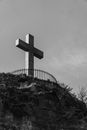 Grayscale Photo of Cross on Rock