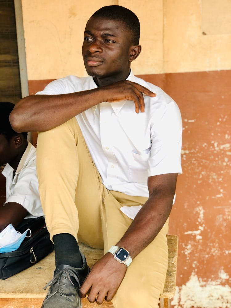 A  Young Man In White Polo And Khaki Pants