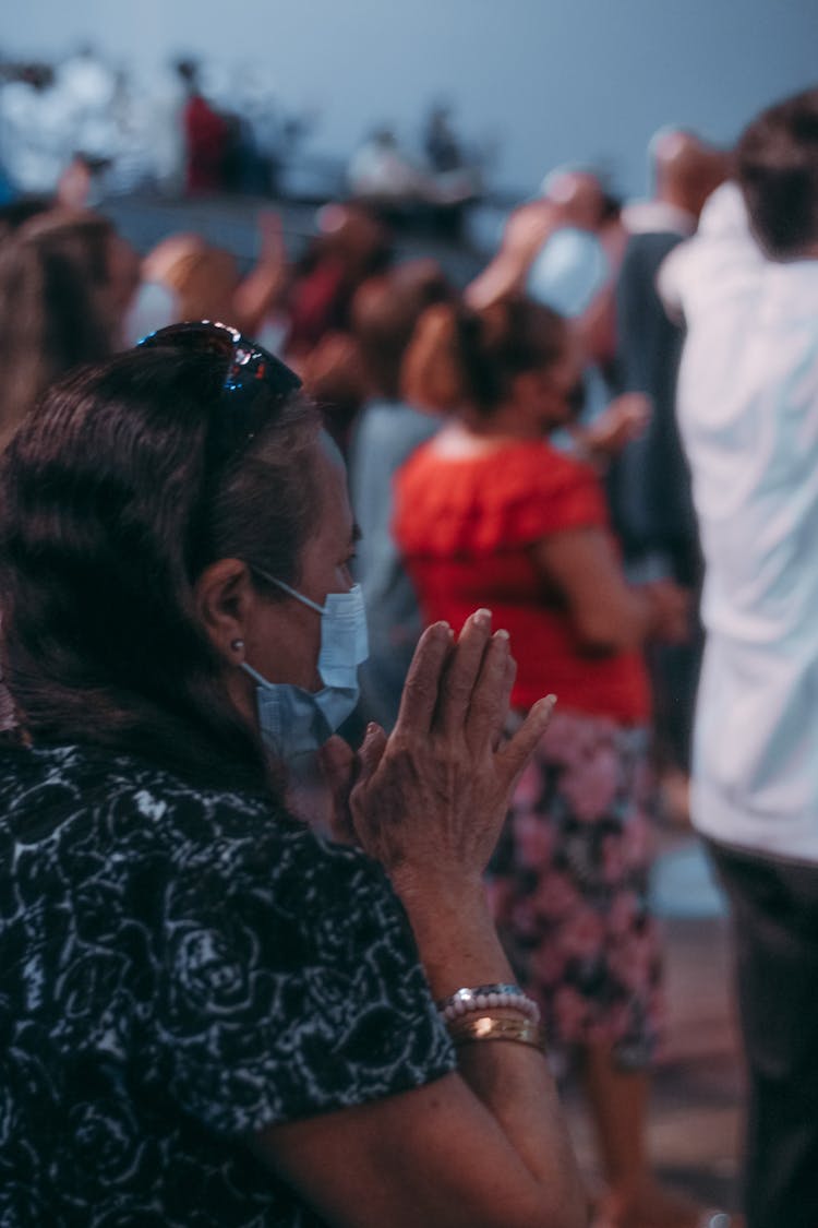 Elderly Woman Praying With Her Hands Together