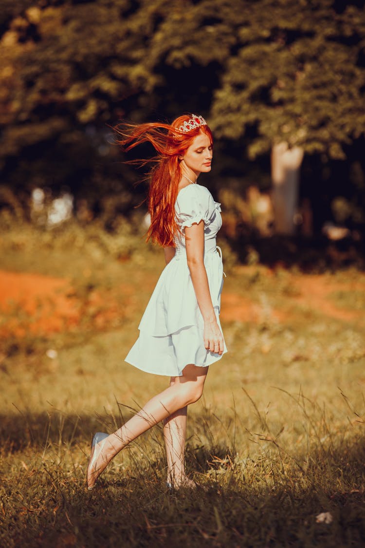 Woman In Tiara Walking Across Meadow