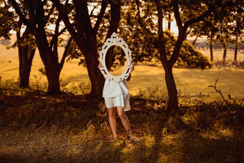 Free A Woman Carrying a Mirror in the Forest Stock Photo