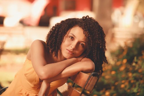 Free A Woman Leaning on a Bench Stock Photo