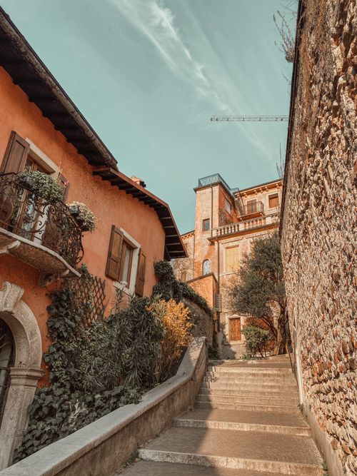Free Historic alley with stone steps and rustic buildings in Mediterranean town. Stock Photo