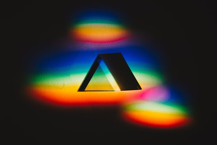 Triangle Illuminated By Rainbow Colored Lights