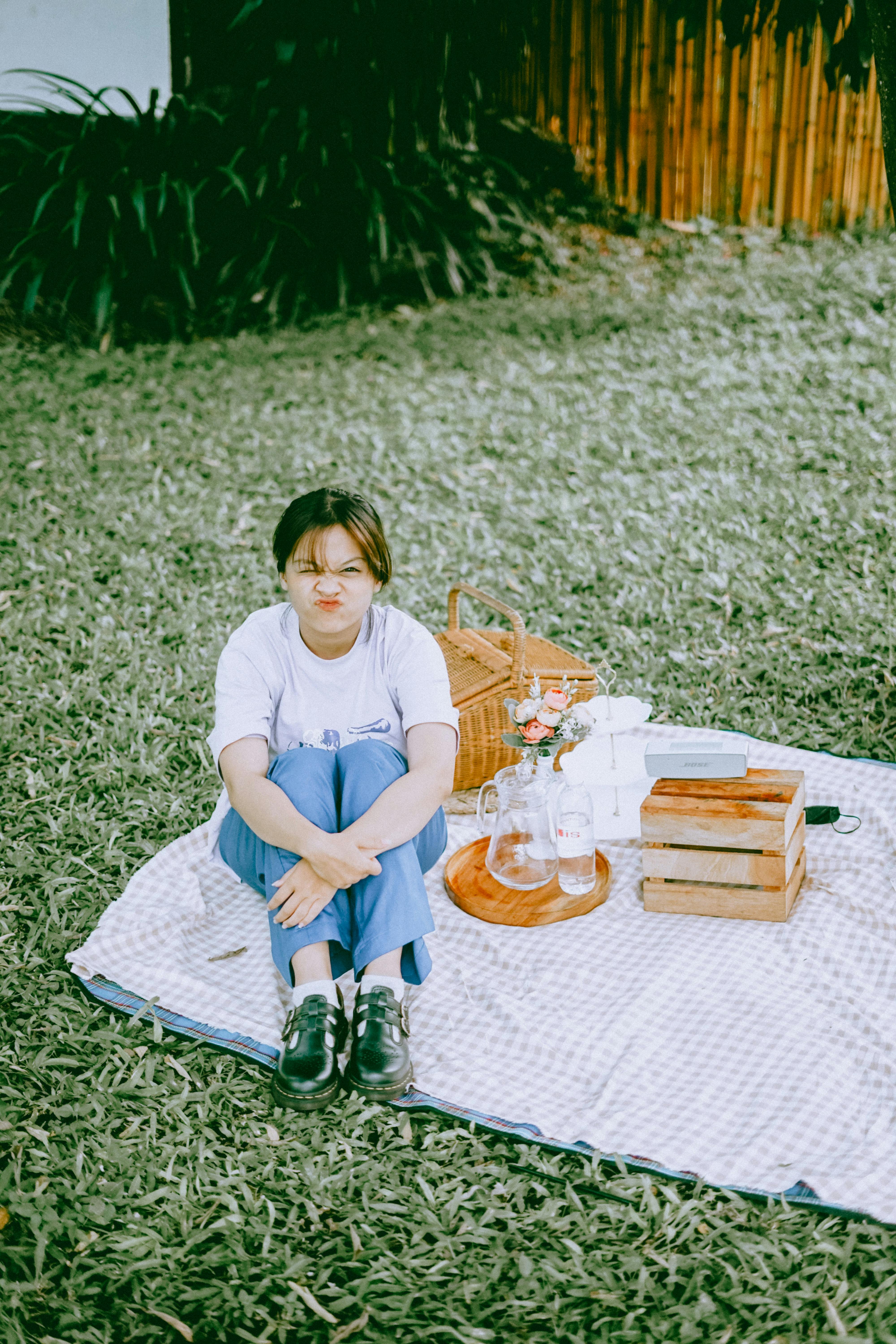 Girl Sitting on a Blanket Pouting Her Lips · Free Stock Photo