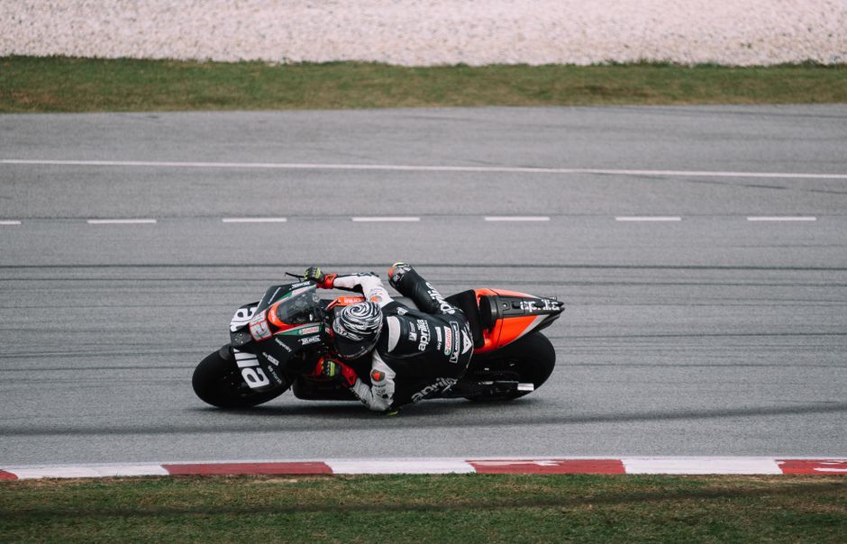 Professional motorcyclist in action on Sepang track. Dynamic and thrilling motorsport moment.