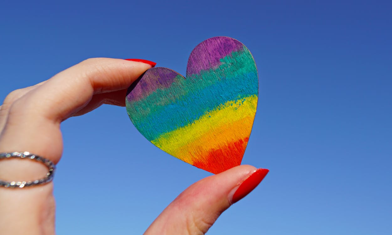 Person Holding Multicolored Heart.