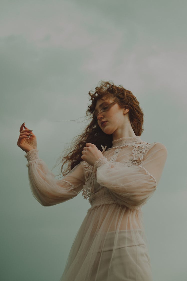 Woman In White Boho Dress On A Windy Day