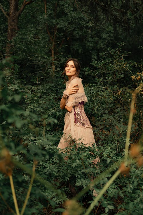 A Woman Wearing Brown Dress in the Forest