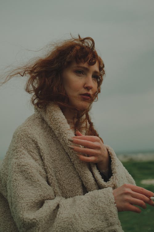 Woman Holding a Cigarette on a Windy Day Outside