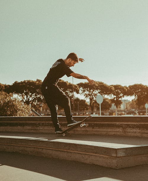 Free Man Doing a Trick on Skateboard Stock Photo