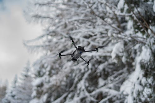 Grayscale Photo of a Flying Drone