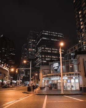 Explore the vibrant nighttime cityscape of Vancouver, showcasing stunning modern architecture in an urban setting.