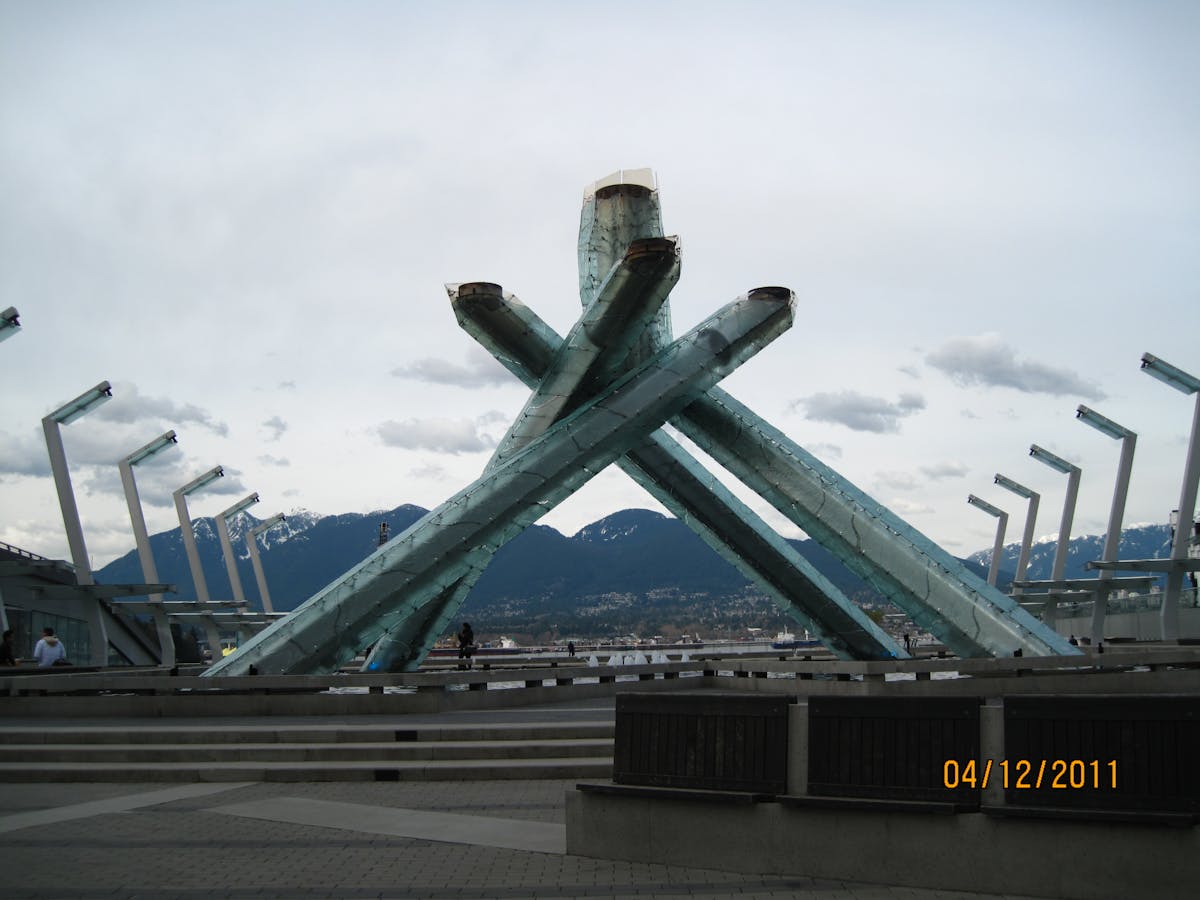 Finished grain bowl topped with vegetables, kimchi, and dressing on a table