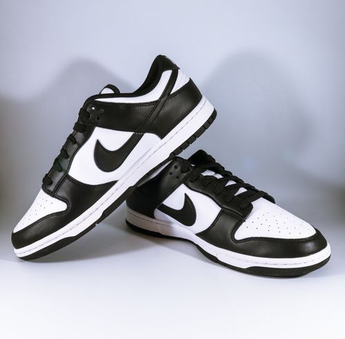 Free Close-up of black and white sneakers on a white background, perfectly showcasing modern footwear style. Stock Photo