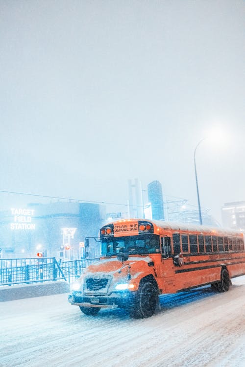 School Bus Driving on Snowy Road