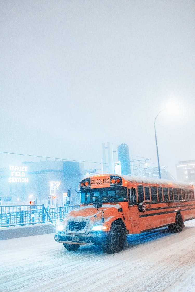 School Bus Driving On Snowy Road