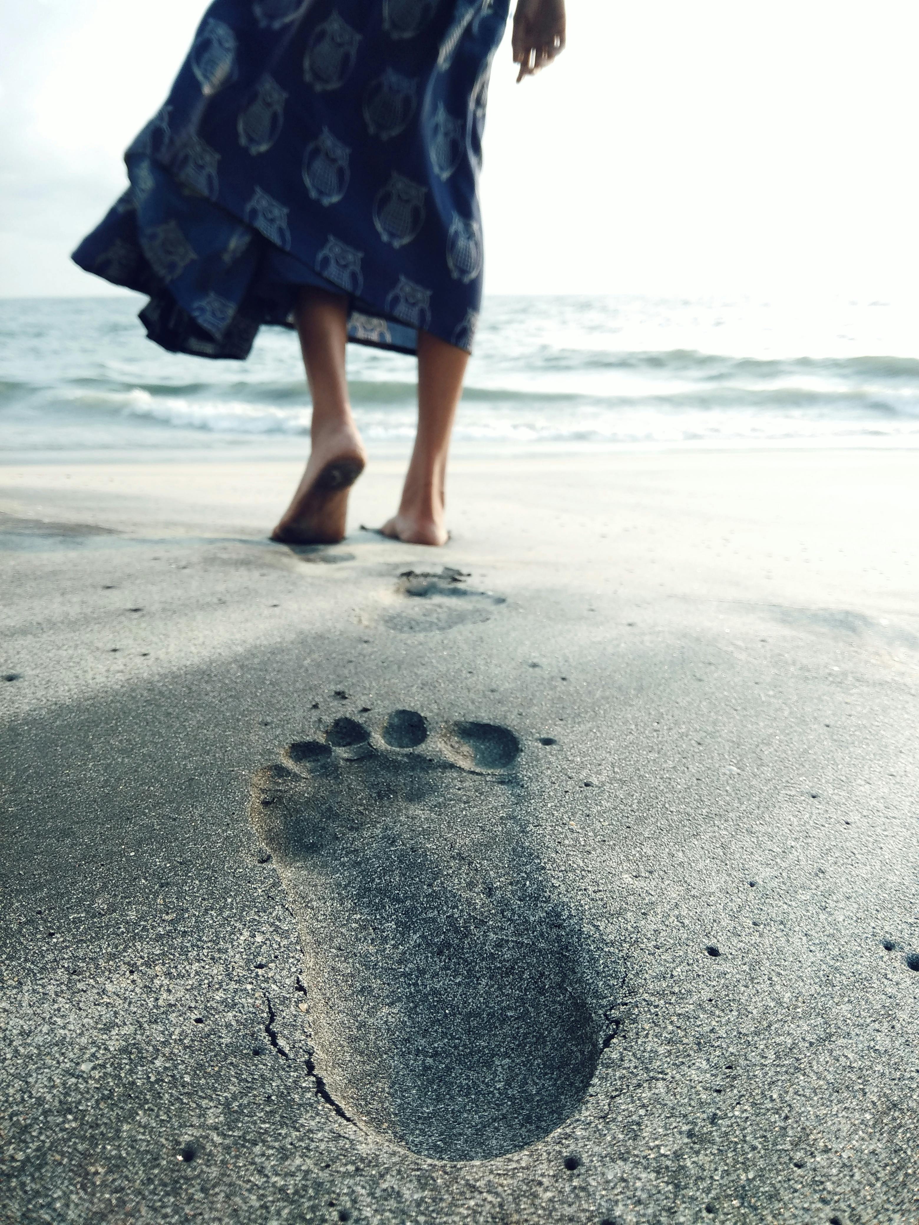 Woman at Beautiful Beach. Focus on Footprints. Stock Photo - Image