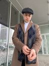 Man in Black Knit Cap and Brown Coat Holding Smartphone