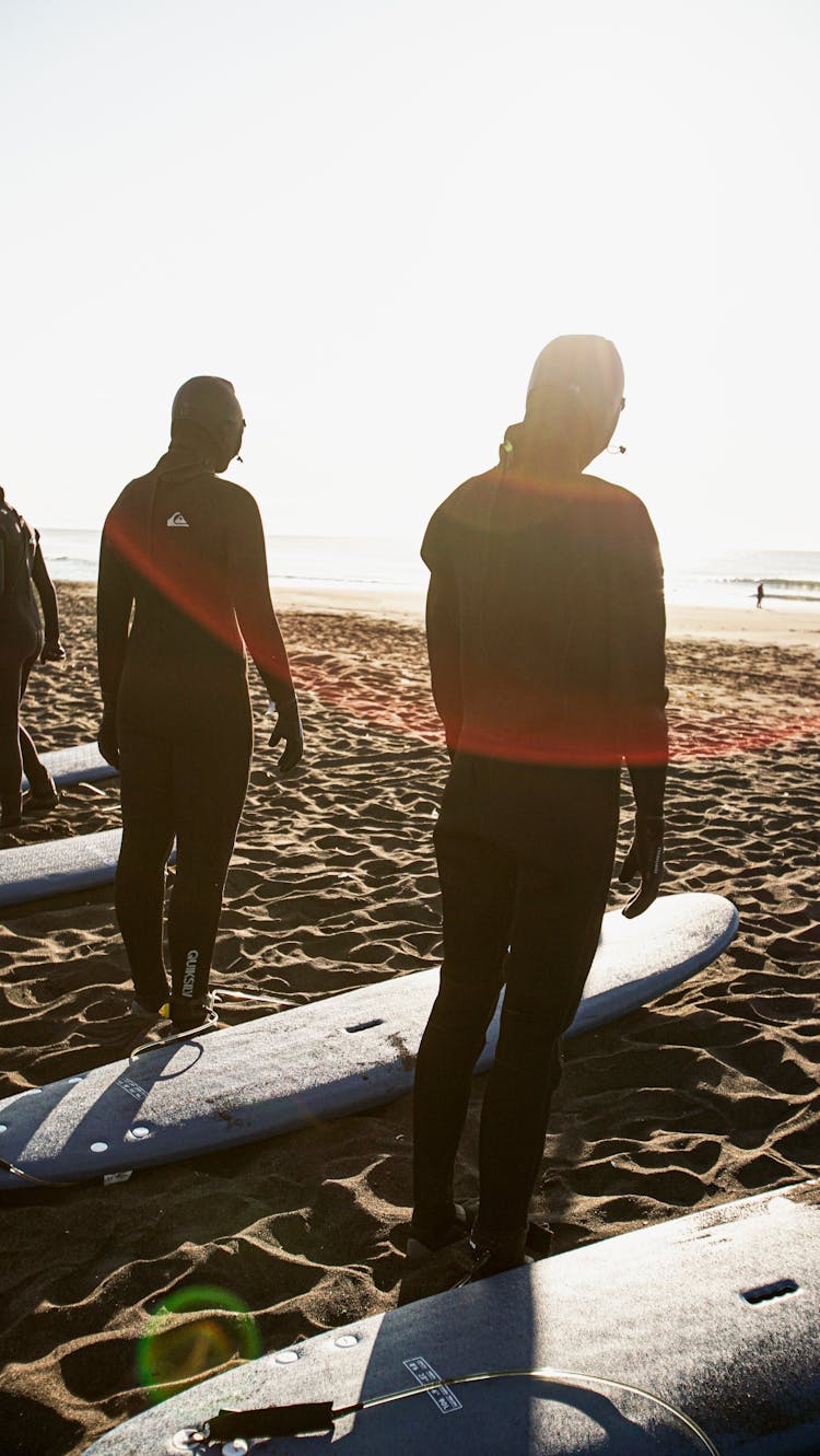 Surfers Standing On The Shore