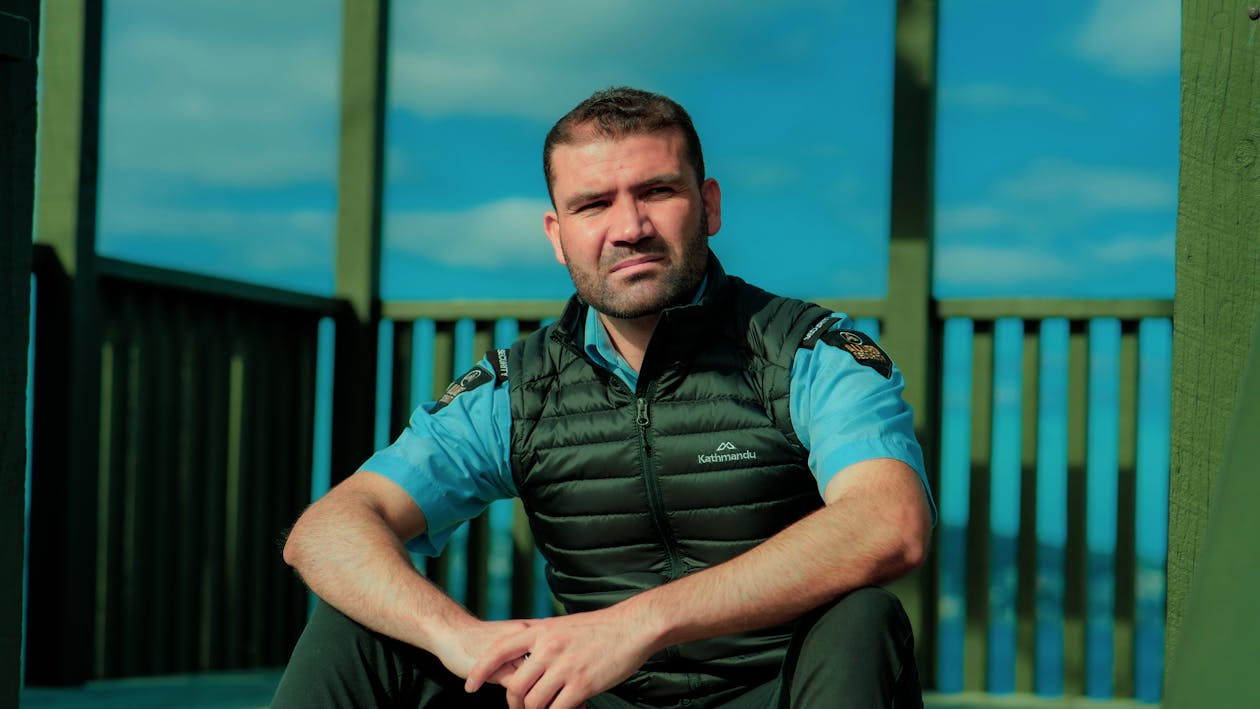 Free Man Wearing a Black Vest over a Uniform Stock Photo